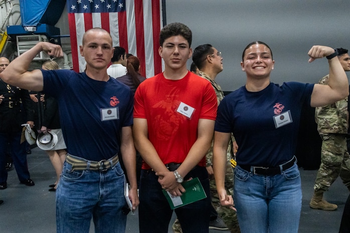 U.S. Marine Corps poolees with Recruiting Station San Diego pose for a photograph at Our Community Salutes San Diego 2024 at the USS Midway Museum in San Diego, Calif., May 20, 2024. The Our Community Salutes program recognizes and supports high school seniors who plan to enlist into the military immediately after high school graduation, and provide them with resources that aid in their transition into military service. (U.S. Marine Corps photo by Sgt. Jesula Jeanlouis)