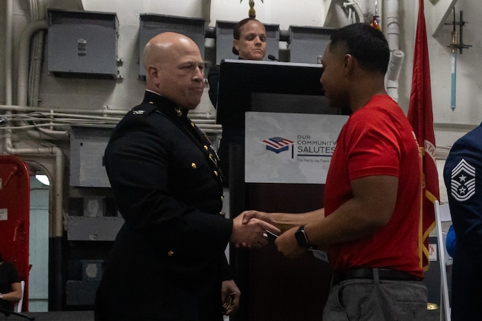 U.S. Marine Col. Jason Freeby, commanding officer of Headquarters and Service Battalion, Marine Corps Recruit Depot San Diego, shakes hands with poolees with Recruiting Station San Diego at Our Community Salutes San Diego 2024 at the USS Midway Museum in San Diego, Calif., May 20, 2024. The Our Community Salutes program recognizes and supports high school seniors who plan to enlist into the military immediately after high school graduation, and provide them with resources that aid in their transition into military service. (U.S. Marine Corps photo by Sgt. Jesula Jeanlouis)