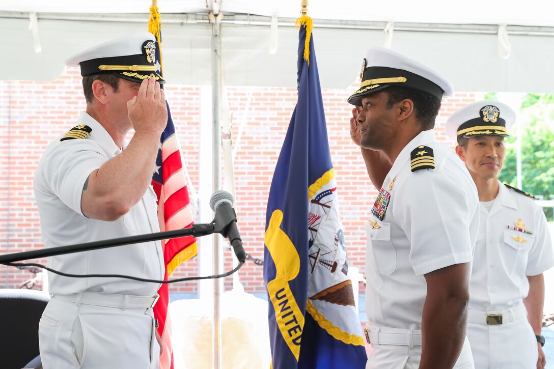 Naval Surface Warfare Center Indian Head Division Commanding Officer CAPT Steve Duba (left) salutes Cmdr. Stan Allen (center) as he assumes command of Expeditionary Exploitation Unit ONE (EXU-1) at the change of command ceremony held in Indian Head, Md., May 30. Outgoing EXU-1 Commanding Officer Cmdr. Eric Hui stands to the right.