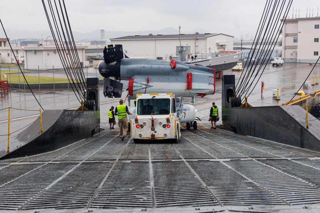 A MV-22 Osprey tiltrotor aircraft is towed off the vehicle carrier vessel Green Lake at Marine Corps Air Station Iwakuni, Japan, May 28, 2024. The aircraft was offloaded from the vehicle carrier ship Green Lake to be delivered to the Japan Ground Self-Defense Force. MCAS Iwakuni is the only Marine Corps installation with a deep-water port and an airfield, giving the air station a unique position to support the dynamic transportation of various military assets throughout the Indo-Pacific. (U.S. Marine Corps photo by Lance Cpl. David Getz)