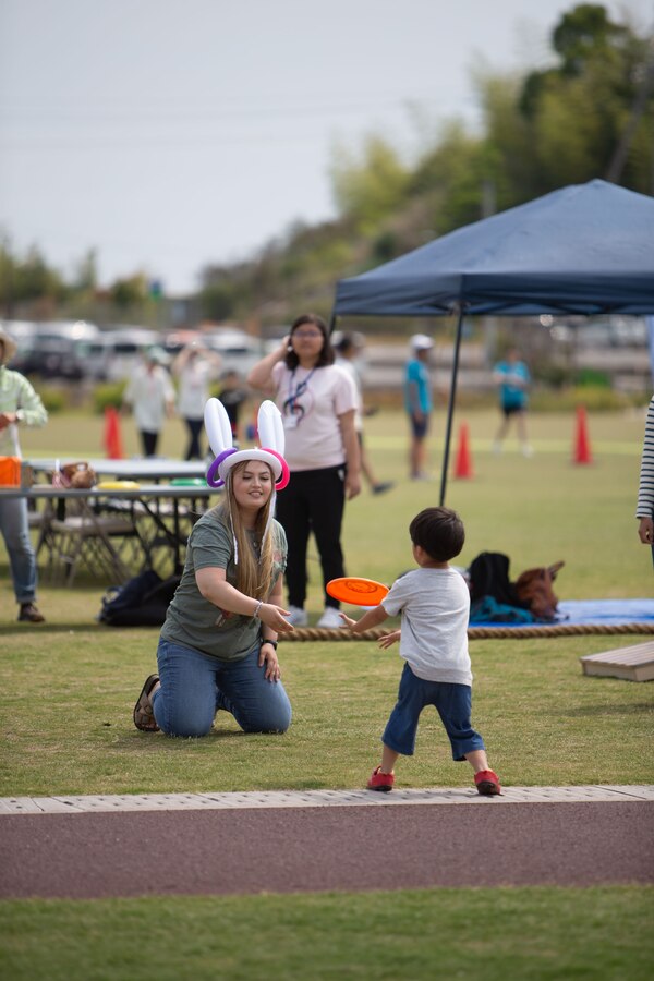 U.S. Navy Hospital Corpsman 3rd Class Shelby Calderon, left, a dental technician with Naval Family Branch Clinic Iwakuni, and a native of Texas, plays frisbee with a child during an Owl Park Inclusive Day community relations event at the Atagoyama Fukuro Park, also known as the Atago Owl Park, Iwakuni, Japan, May 26, 2024. The event provided MCAS Iwakuni volunteers an opportunity to connect with the local community and offered a safe environment for children with special needs to enjoy a day at the park with U.S. service members and others. (U.S. Marine Corps photo by Sgt. Phuchung Nguyen)