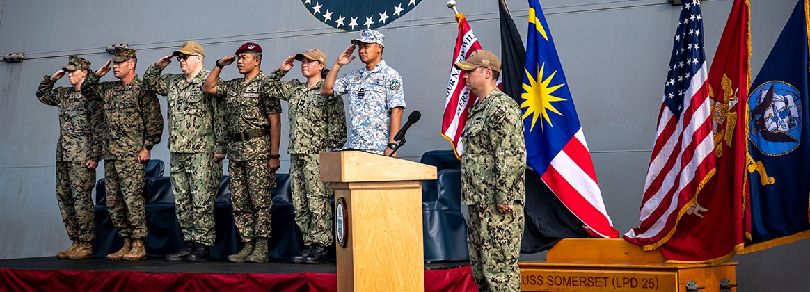 240529-N-ME861-1140 KUANTAN, Malaysia (May 29, 2024) U.S. and Malaysian leaders render honors during the opening ceremony of Tiger Strike 2024 aboard USS Somerset (LPD 25) in Kuantan, Malaysia, May 29, 2024. Tiger Strike is a bilateral exercise between U.S. and Malaysia armed forces designed to enhance communication and build combat readiness through combined amphibious operations and subject matter expert exchanges in support of a shared vision for security and stability in the region. (U.S. Navy photo by Mass Communications Specialist 2nd Class James Finney)
