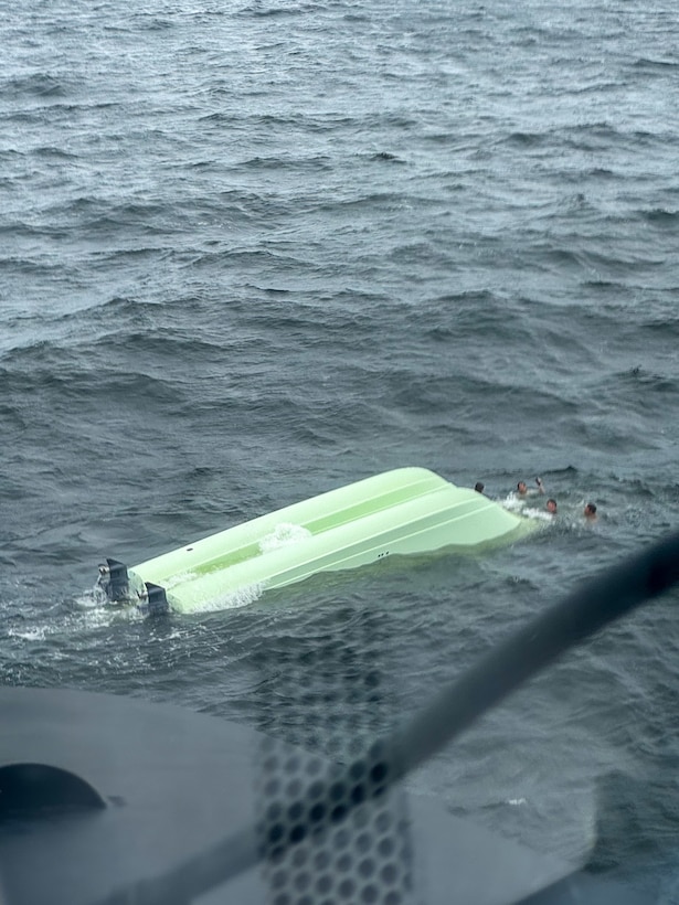 A capsized vessel floats in the ocean near Dauphin Island, Alabama, May 30, 2024. The Coast Guard rescued four boaters from the capsized Catamaran. (U.S. Coast Guard photo by Petty Officer 3rd Class Ryan Reed