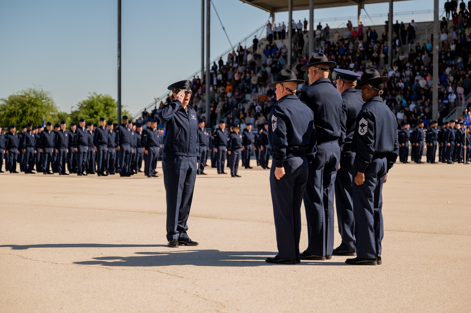 Col. Lauren Courchaine, 37thTraining Wing commander, salutes the flag during the April 3, 2024, Airman’s Coin & Retreat Ceremony at Joint Base San Antonio-Lackland, Texas. More than 500 Airmen graduated from Basic Military Training where Courchaine served as the Commander of Airmen for the retreat ceremony. Courchaine is changing command May 30 and will move into her new role as the Senior Military Assistant to the Under Secretary of the Air Force at the Pentagon, Washington D.C. (U.S. Air Force photo by Gregory T. Walker)