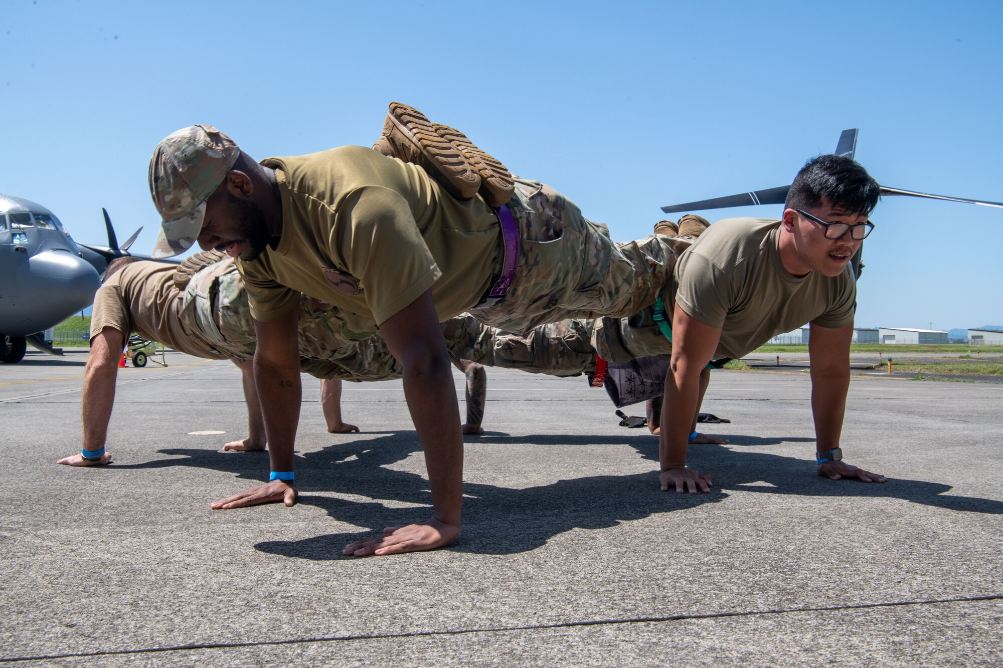 Airmen assigned to the 374th Maintenance Group participate in a push-up contest during the Maintenance Professional of the Year celebration.
