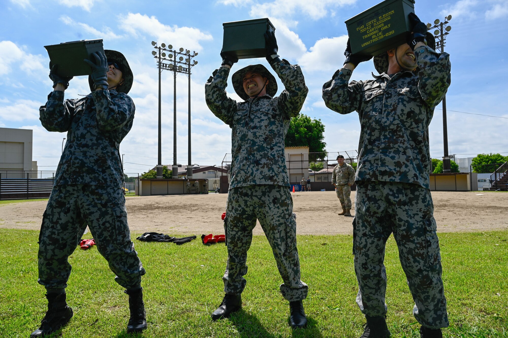 A team of people hold up cartons.