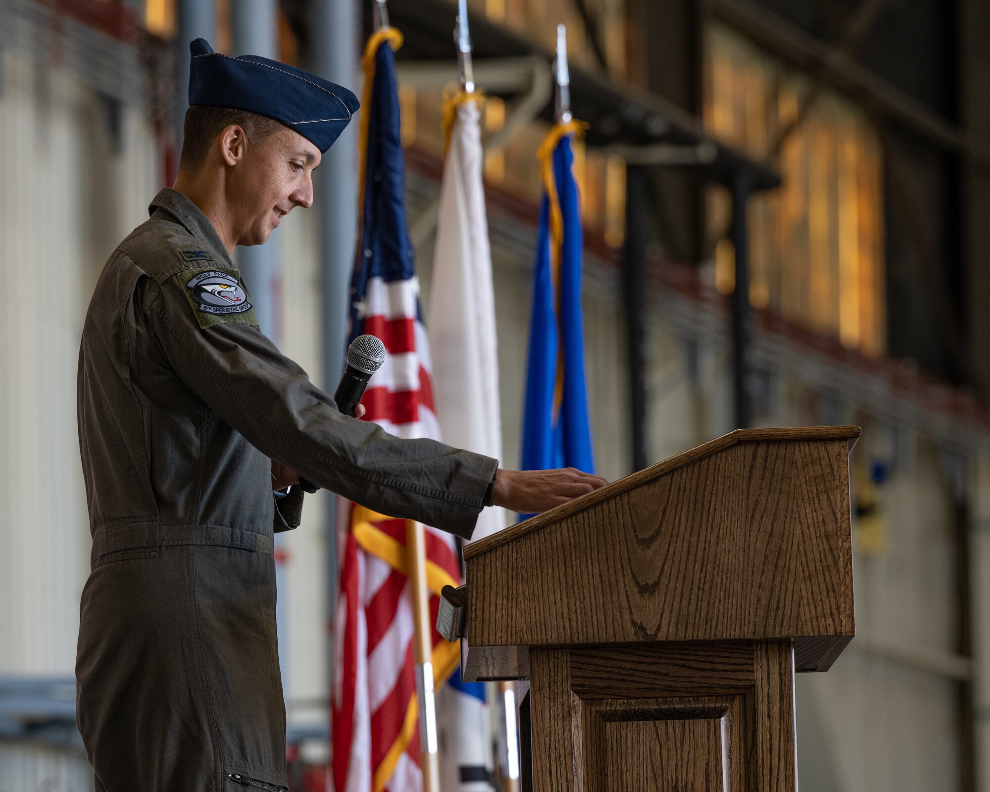 Col. Michael McCarthy, 8th Operations Group outgoing commander,  speaks to attendees during the 8th OG change of command ceremony.