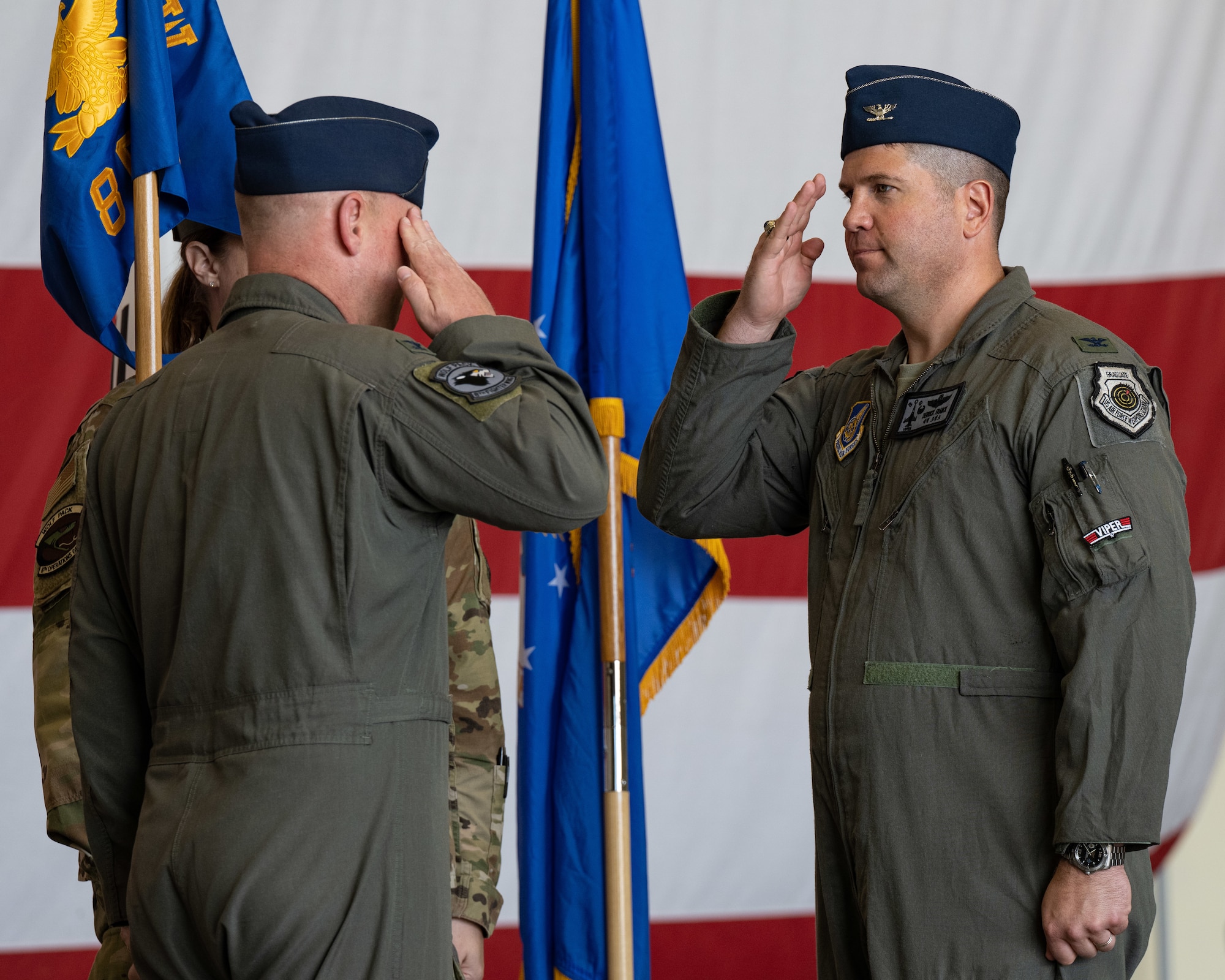 Col. Derrick Franck, 8th Operations Group incoming commander, salutes Col. Matthew Gaetke, 8th Fighter Wing commander, after assuming command of the 8th OG during the 8th OG change of command ceremony.