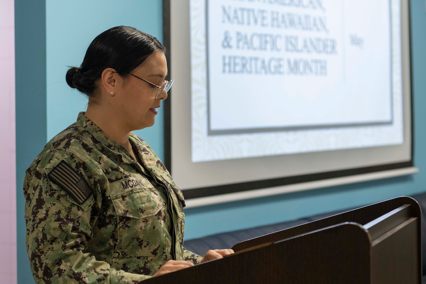 Mass Communication Specialist Seaman Apprentice Kristine McDavid, assigned to American Forces Network Souda Bay, acts as the master of ceremonies during an Asian American, Native Hawaiian, and Pacific Islander Heritage Month celebration with the theme of “Advancing Leaders Through Innovation” in The Anchor on May 30, 2024.