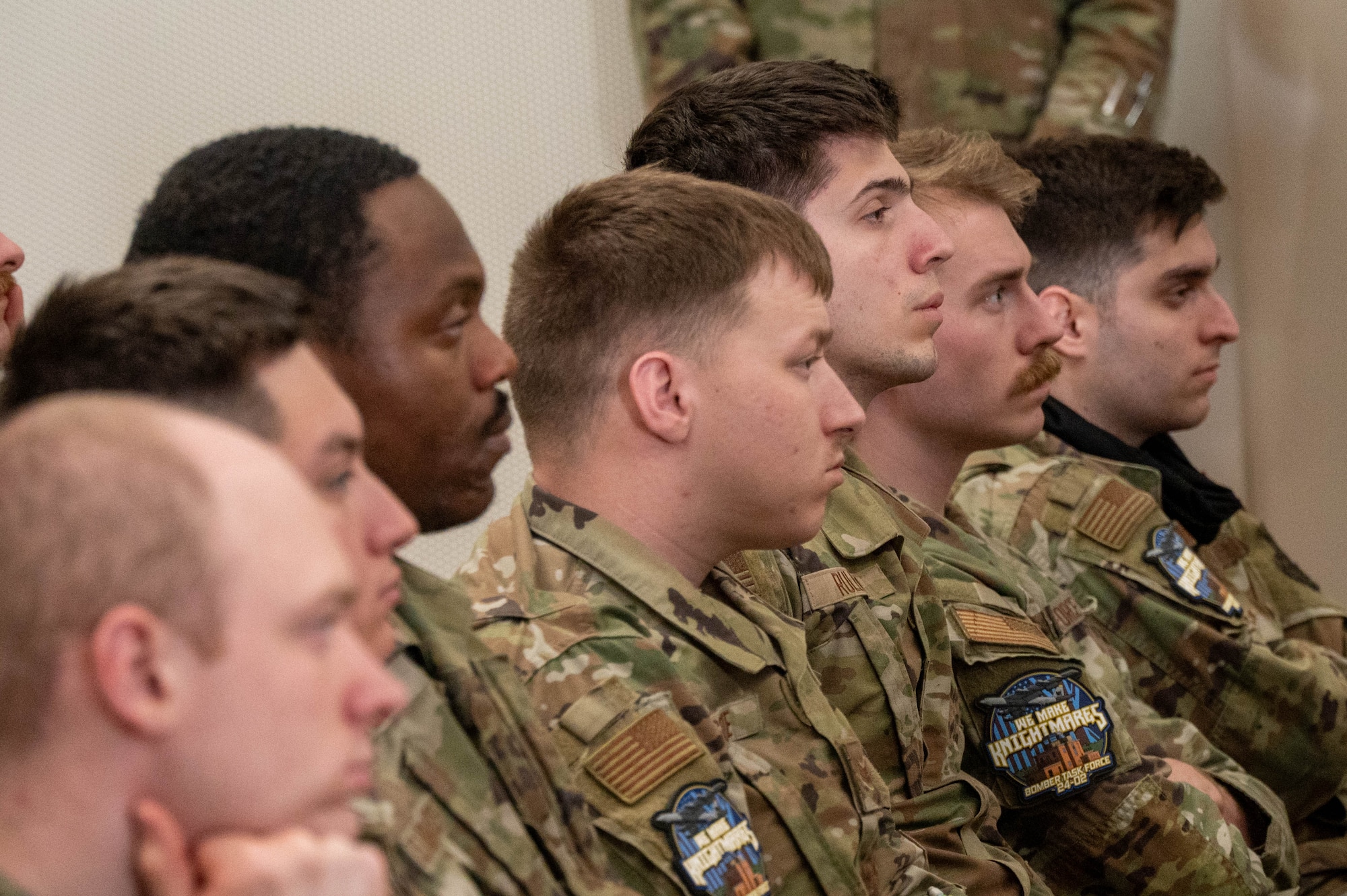 Airmen deployed from Minot Air Base listen to an in-processing brief