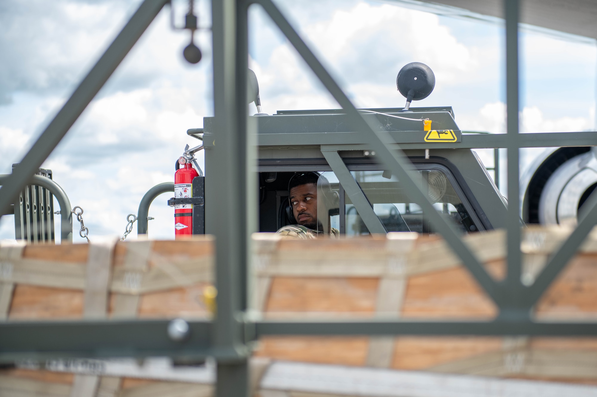 A driver looks to his spotter for guidance as he operates a K-loader during an offload