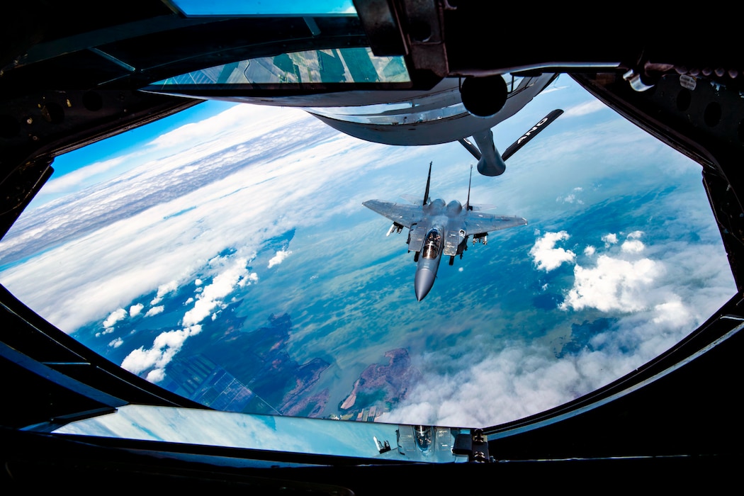 An F-15E Strike Eagle with the 4th Fighter Wing approaches a KC-135 Stratotanker from the 121st Air Refueling Wing to be refueled over the skies of North Carolina