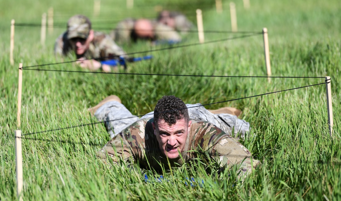Lt. Col. Andrew Fergussen, 55th Security Forces Squadron commander, low crawls under wire