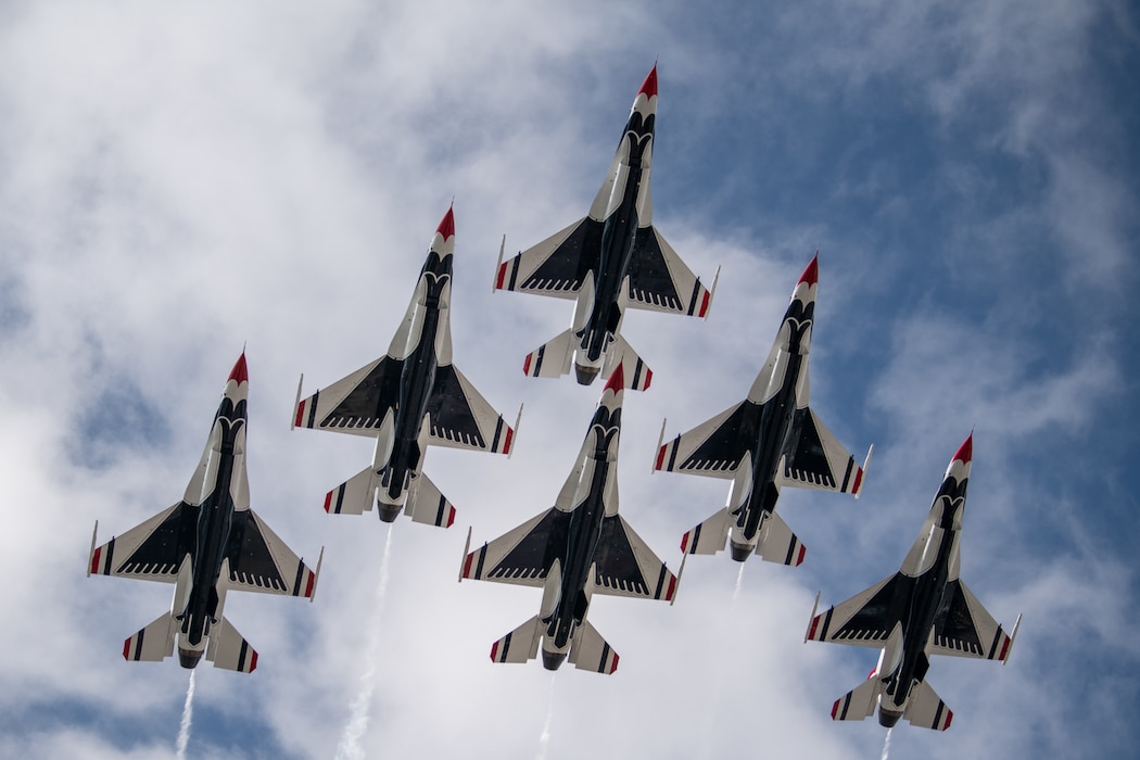 A formation of F-16 Fighting Falcons assigned to the U.S. Air Force Air Demonstration Squadron, the Thunderbirds, perform