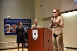 Walter Reed director U.S. Navy Capt. (Dr.) Melissa Austin (3rd from left) introduces U.S. Army Lt. Col. (Dr.) Jamie Diaz Robinson (left) and U.S. Army Chaplain (Maj.) Vincent Bain (center) during a Grand Rounds forum on May 21 in Clark Auditorium in Bethesda, Maryland.