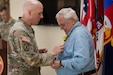 Brig. Gen. Lance Calvert, left, director of the U.S. Army Reserve Command G-3/5/7 and former aviator presents the Master Aviator Badge to retired Lt. Col. James R. Schrum during a ceremony at Fort Liberty, North Carolina, on May 28, 2024. Schrum served in the Army as an aviator from 1960 to 1980.