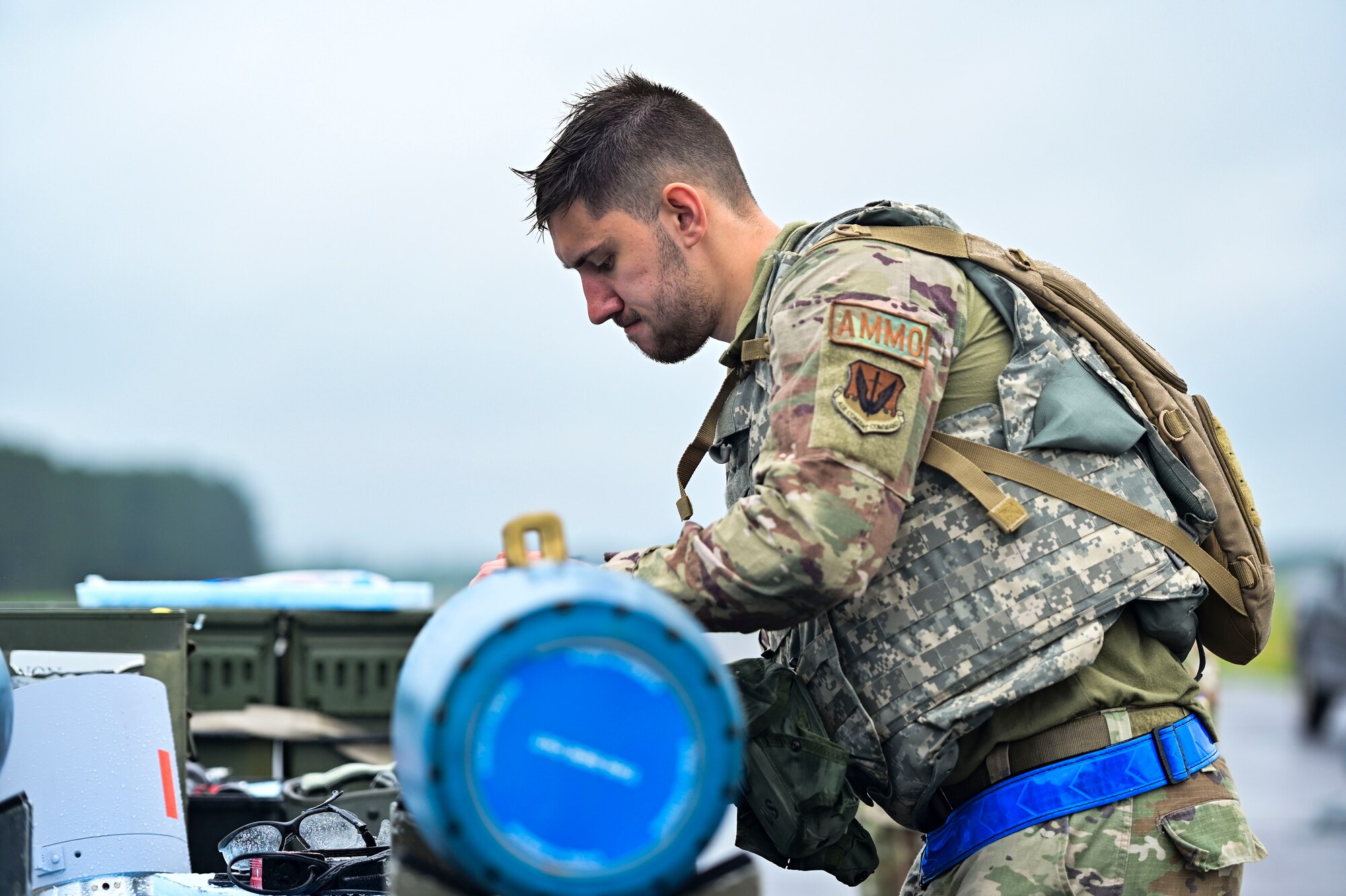 Airmen working on a bomb outside.