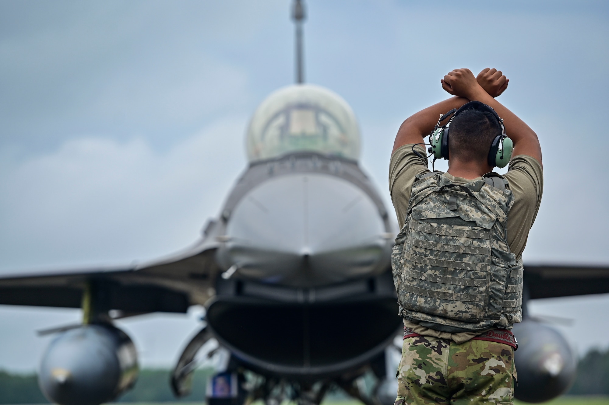 Airmen leading the way to an jet.