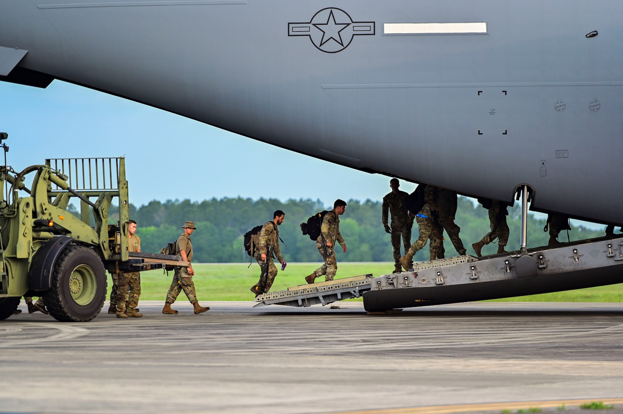 Airmen walking into aircraft.