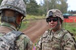 Maj. Gen. Kenneth S. Hara, Hawaii adjutant general, speaks to a 103rd Troop Command Soldier during individual weapon qualification, Schofield Barracks, Hawaii, June 5, 2021.