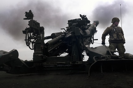 Spc. Megan Cox, with B Battery, 2nd Battalion, 123rd Field Artillery Regiment, Illinois Army National Guard, pulls the lanyard to fire an M777 155mm howitzer while executing a fire mission during exercise Immediate Response in Ustka, Poland, May 10, 2024. More than 10,400 U.S. military members and 12,750 service members from allied and partner nations are participating in the exercise, which includes live-fire exercises, wet gap crossings, and other training to strengthen interoperability among participants.