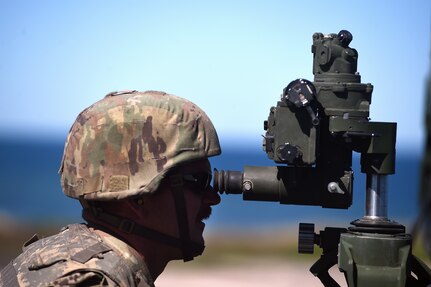 U.S. Army Sgt. Eric Vincent, a cannon crewmember with B Battery, 2nd Battalion, 123rd Field Artillery Regiment, Illinois Army National Guard, adjusts the targeting data on an M777 155mm howitzer while executing a fire mission during exercise Immediate Response in Ustka, Poland, May 12, 2024. More than 22,000 service members from the United States, Poland, the Czech Republic, and the United Kingdom are participating in the exercise, which includes live-fire exercises, wet gap crossings, and other training to strengthen interoperability.