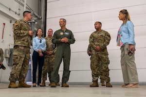 military members talk in a hangar
