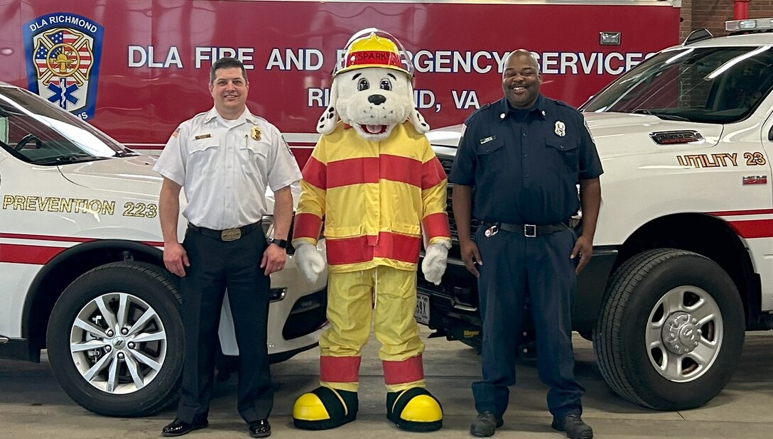 Richmond Firemen pose with Sparky the Fire Dog.