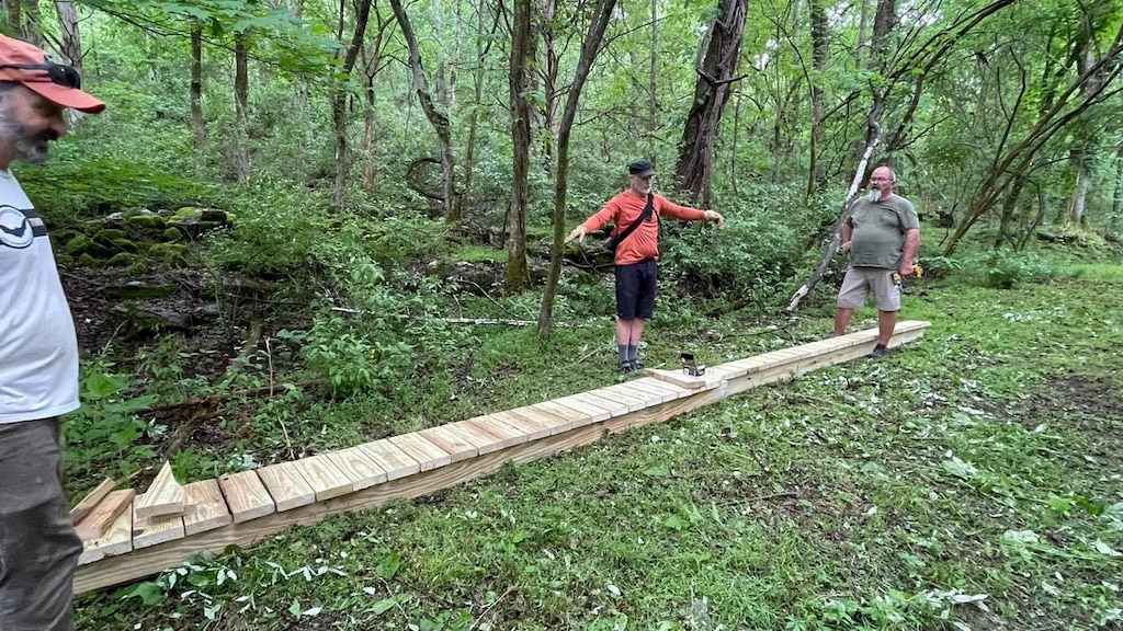 Volunteers from Upper Cumberland Southern Off-Road Bicycle Association make improvements with a new low-profile skinny on the Bear Waller Gap Mountain Bike Trail May 4, 2024, on the shoreline of Center Hill Lake. The public can go hiking on more than 470 miles of trails at 10 U.S. Army Corps of Engineers lakes in the Cumberland River Basin on National Trails Day June 1, 2024. There are also dedicated biking trails available. (USACE Photo by Ashley Webster)