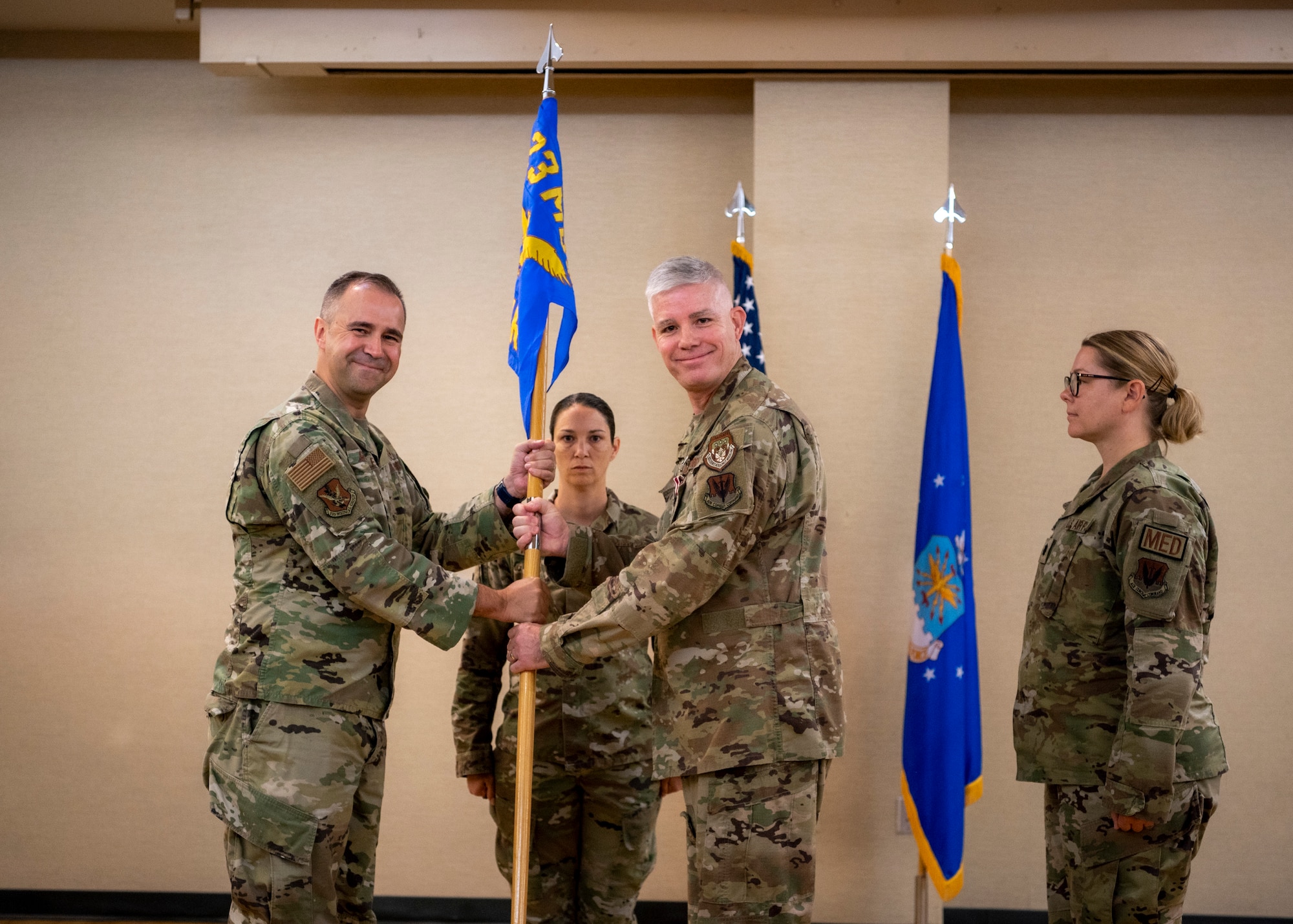 U.S. Air Force Col. Christopher Gonzales, 23rd Medical Group commander, left, passes the guidon to Lt. Col. Megan Martin, 23rd Operational Medical Readiness Squadron incoming commander, during a change of command ceremony at Moody Air Force Base, Georgia, May 23, 2024. Prior to becoming the commander of the 23rd OMRS, she was the public health flight commander at Moody AFB. (U.S. Air Force photo by Airman 1st Class Leonid Soubbotine)