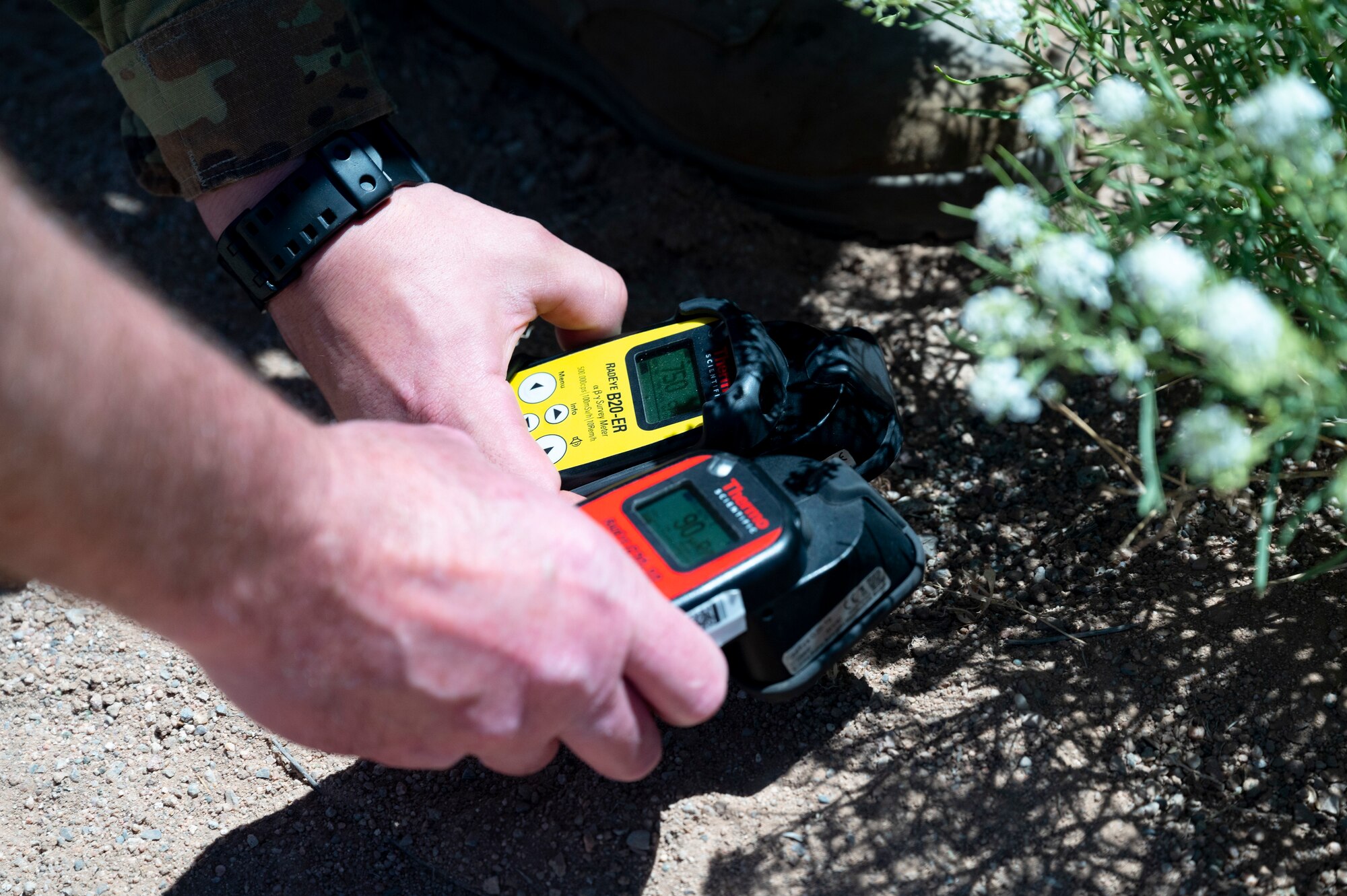 People measure radiation detection equipment.