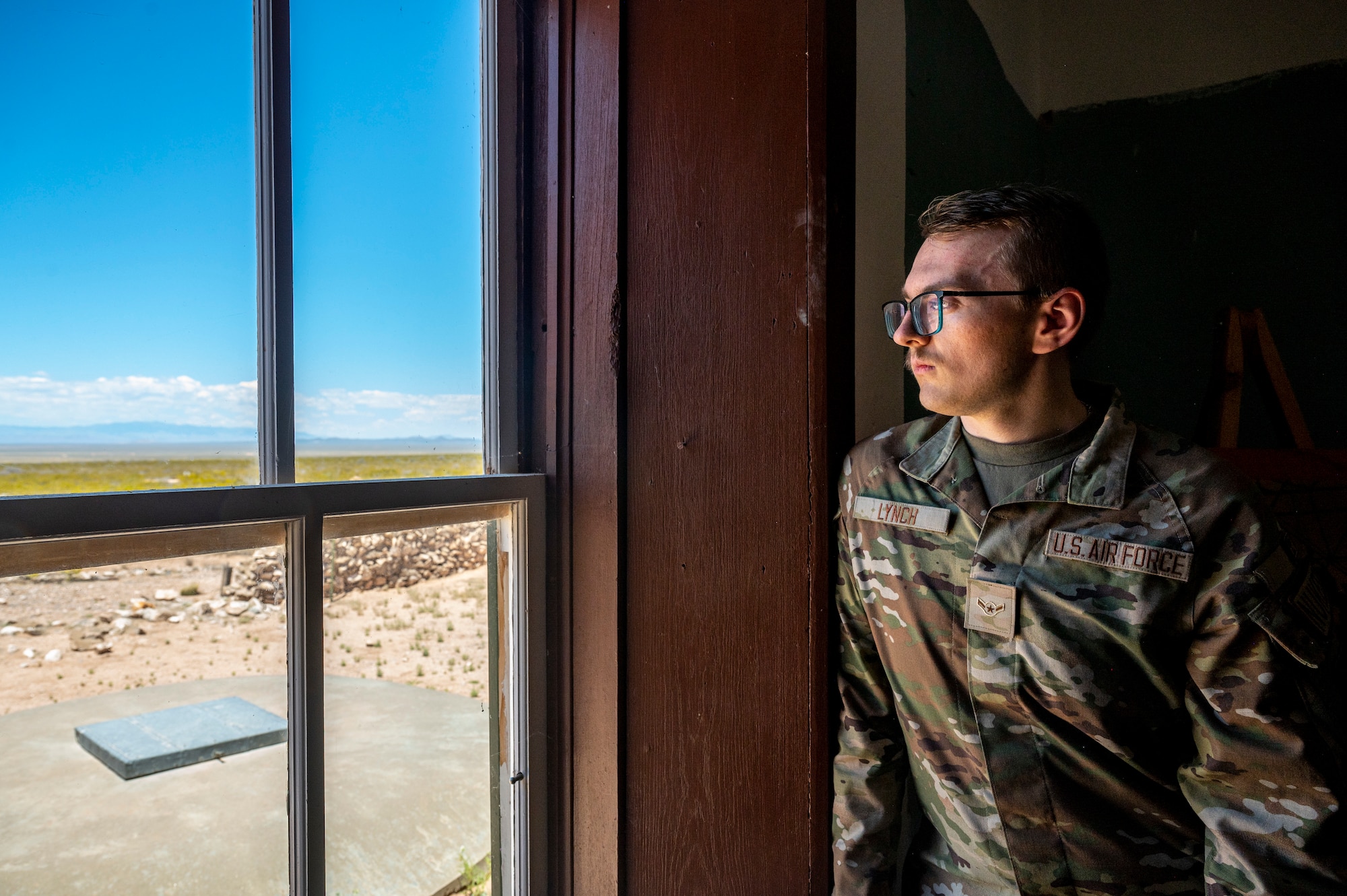 Man looks outside window.