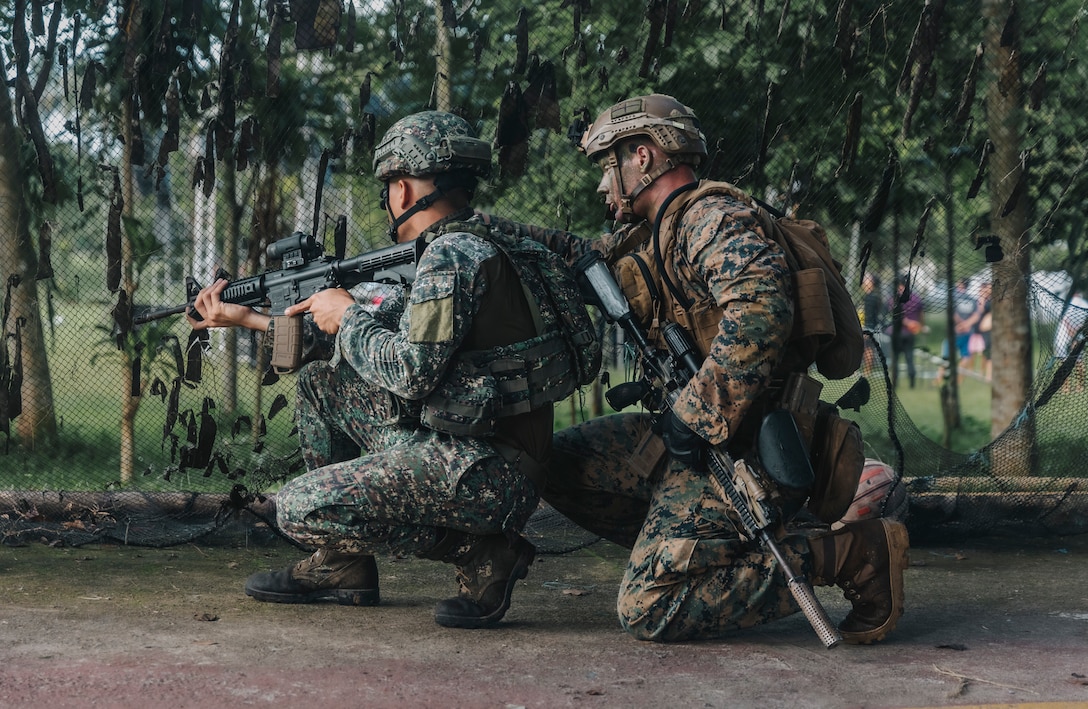 U.S. Marine Corps Lance Cpl. Michael Georges, right, a rifleman with 1st Battalion, 7th Marine Regiment, 1st Marine Division, instructs a Philippine Marine with 1st Marine Brigade during the final exercise for Archipelagic Coastal Defense Continuum in Barira, Philippines, May 28, 2024. The final exercise consisted of a bilateral company-level element conducting close-quarter combat and patrol-based operations. ACDC is a series of bilateral exchanges and training opportunities between the U.S. Marines and Philippine Marines aimed at bolstering the Philippine Marine Corps’ Coastal Defense strategy while supporting the modernization efforts of the Armed Forces of the Philippines. Georges is a South Dakota native. (U.S. Marine Corps photo by Sgt. Shaina Jupiter)