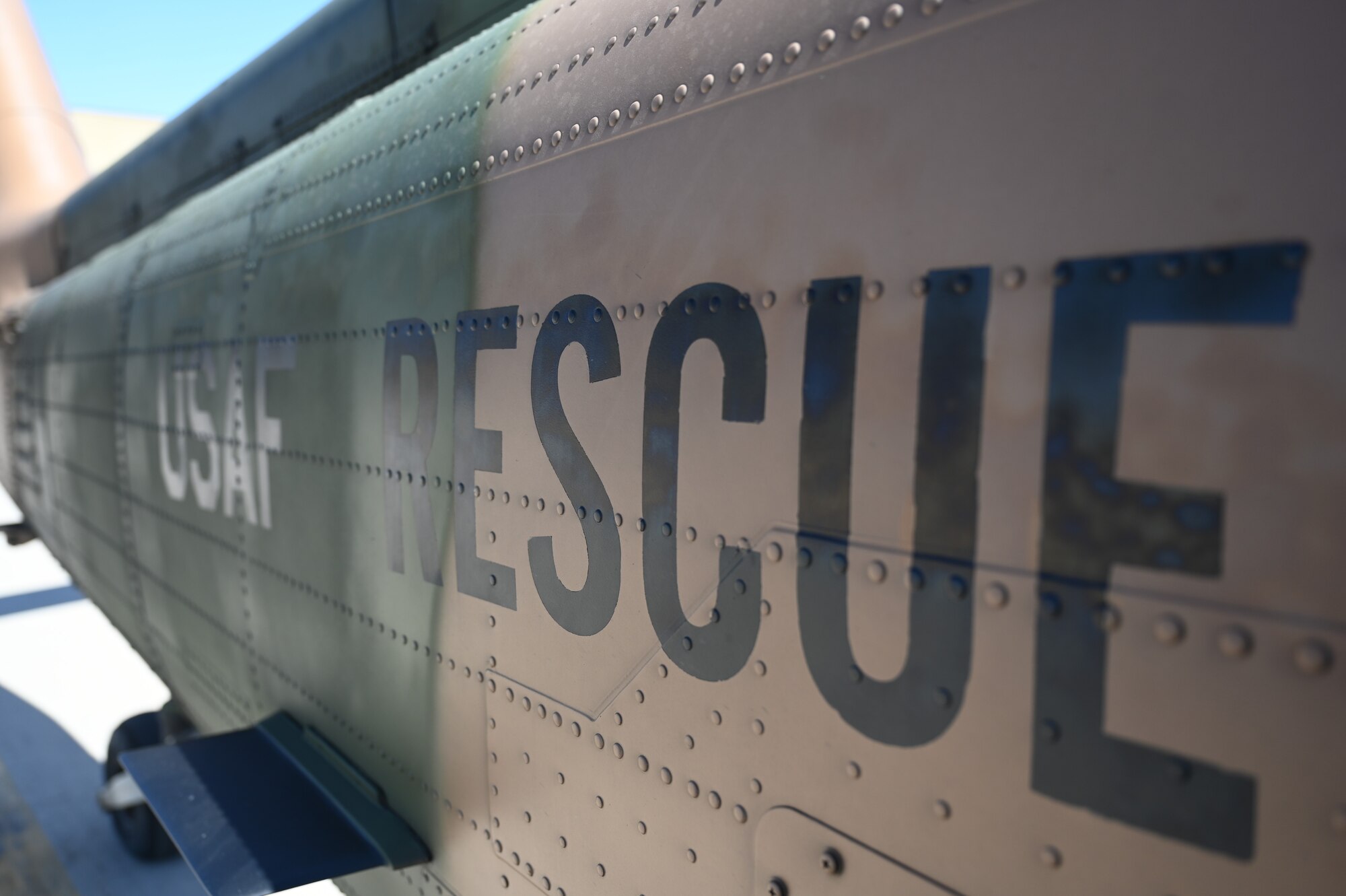 An HH-60G Pave Hawk helicopter repainted a unique color scheme ahead of its official retirement at Davis-Monthan Air Force Base, Ariz., May 6, 2024. The aircrew has performed over 7000 flight hours on the helicopter and trained over 300 pilots. (U.S. Air Force photo by Senior Airman Andrew Garavito)