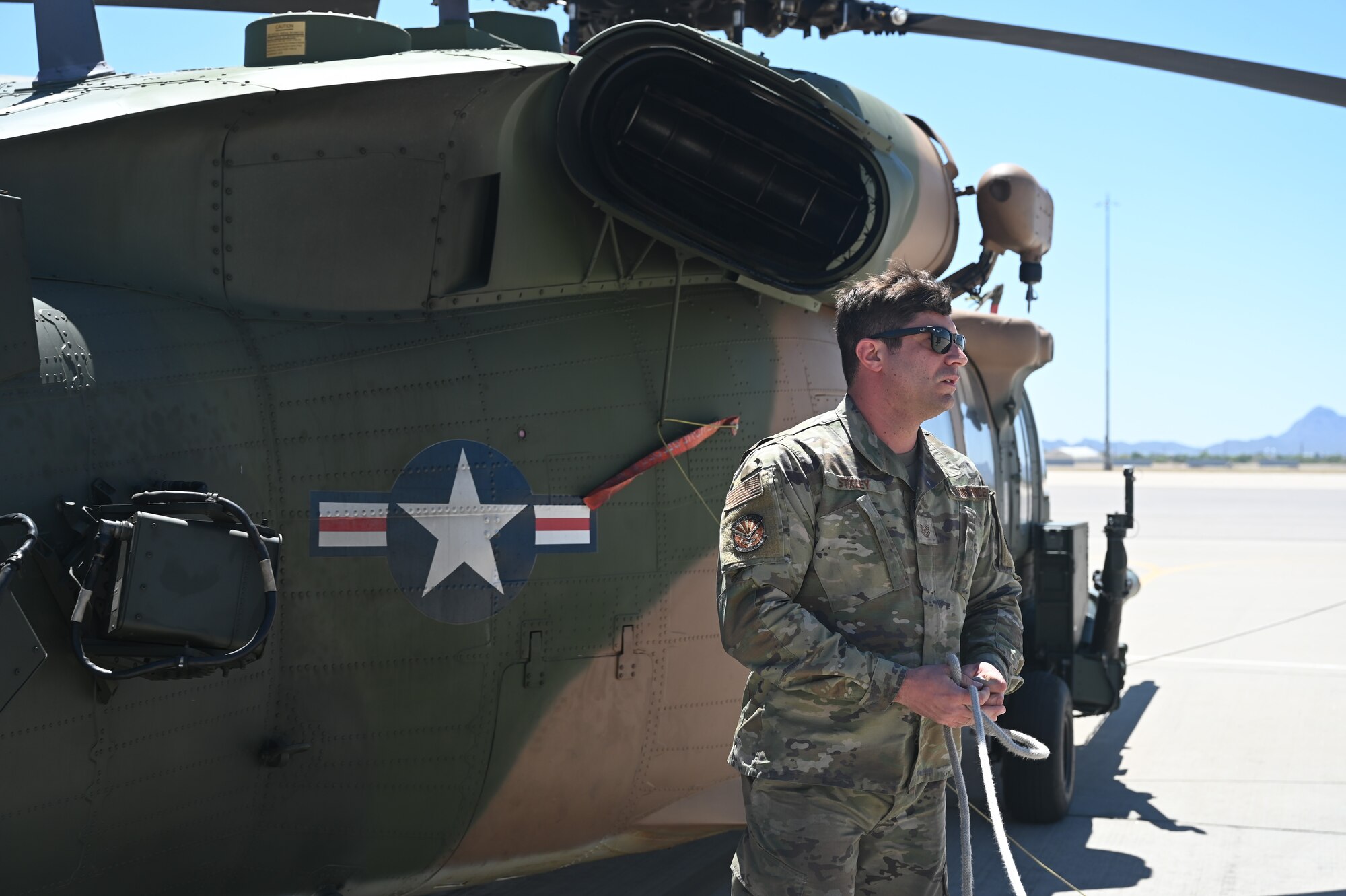 U.S. Air Force Tech Sgt. Anthony Staley, 943rd Maintenance Squadron crew chief, removes a cord from an HH-60G Pave Hawk helicopter on the flightline at Davis-Monthan Air Force Base, Ariz., May 6, 2024. Throughout its service, A6224 has accumulated over 7,204 flight hours. The aircraft has participated in over one thousand successful real--world rescue missions. (U.S. Air Force photo by Senior Airman Andrew Garavito)
