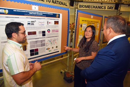 JOINT BASE SAN ANTONIO-FORT SAM HOUSTON – (May 30, 2024) – Dr. Dao Ho, of Dallas, a research immunologist, assigned to the Combat Casualty Care and Operational Medicine Directorate, Naval Medical Research Unit (NAMRU) San Antonio, speaks with Dr. Hakim Bouamar (left), senior scientist of U.S. Air Force 59th Medical Wing’s (MDW) Center for Advance Molecular Detection, and Dr. Darrin Frye, NAMRU San Antonio’s chief science director, about cell-based, in vitro capabilities during the inaugural Promote Professional Engagement amongst Military Laboratories (ProPEL) Science Symposium held at the Center of the Intrepid. The event was designed for researchers within Joint Base San Antonio to better understand the type of work they are conducting to further collaborative opportunities. NAMRU San Antonio is one of the leading research and development laboratories for the U.S. Navy under the Department of Defense (DoD) and is one of eight subordinate research commands in the global network of laboratories operating under the Naval Medical Research Command in Silver Spring, Md.  Its mission is to conduct gap driven combat casualty care, craniofacial, and directed energy research to improve survival, operational readiness, and safety of DoD personnel engaged in routine and expeditionary operations. (U.S. Navy Photo by Burrell Parmer, NAMRU San Antonio Public Affairs/Released)