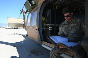 U.S. Air Force Tech Sgt. Anthony Staley, 943rd Maintenance Squadron crew chief, reviews inspection forms for an HH-60G Pave Hawk helicopter at Davis-Monthan Air Force Base, Ariz., May 6, 2024. The Aircrew for this helicopter has performed more than 7000 flight hours on the HH-60G Pave Hawk and trained over 300 pilots. (U.S. Air Force photo by Senior Airman Andrew Garavito)
