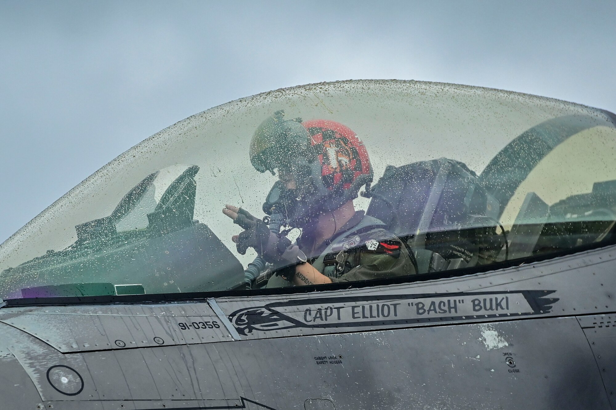 Pilot poses inside a jet.