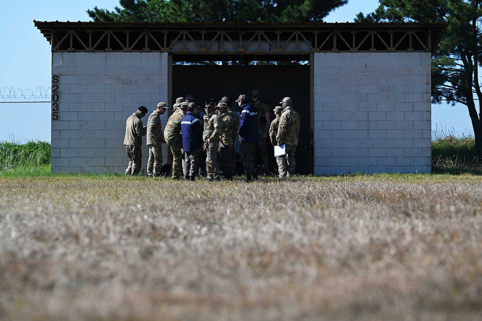 U.S. Airmen assigned to the 8th Civil Engineer Squadron explosive ordnance disposal flight and Republic of Korea Air Force Airmen debrief training results after joint EOD training at Kunsan Air Base, ROK.