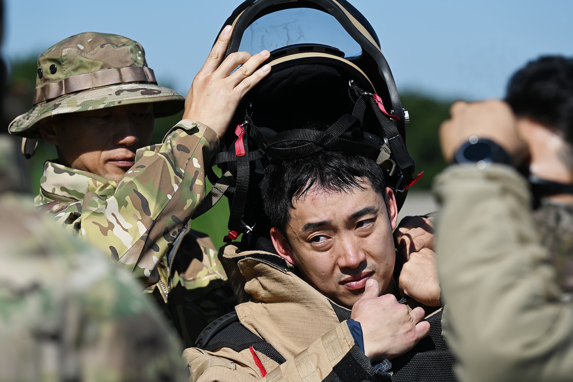 Senior Master Sgt. Park Jeong Hwan, left, Republic of Korea Air Force 5th Air Mobility Wing explosive ordnance disposal technician, removes the bomb suit helmet from Master Sgt. Lee Seung Ho, ROKAF 5th AMW EOD technician, during joint explosive ordnance disposal training with U.S. Airmen at Kunsan Air Base, ROK.