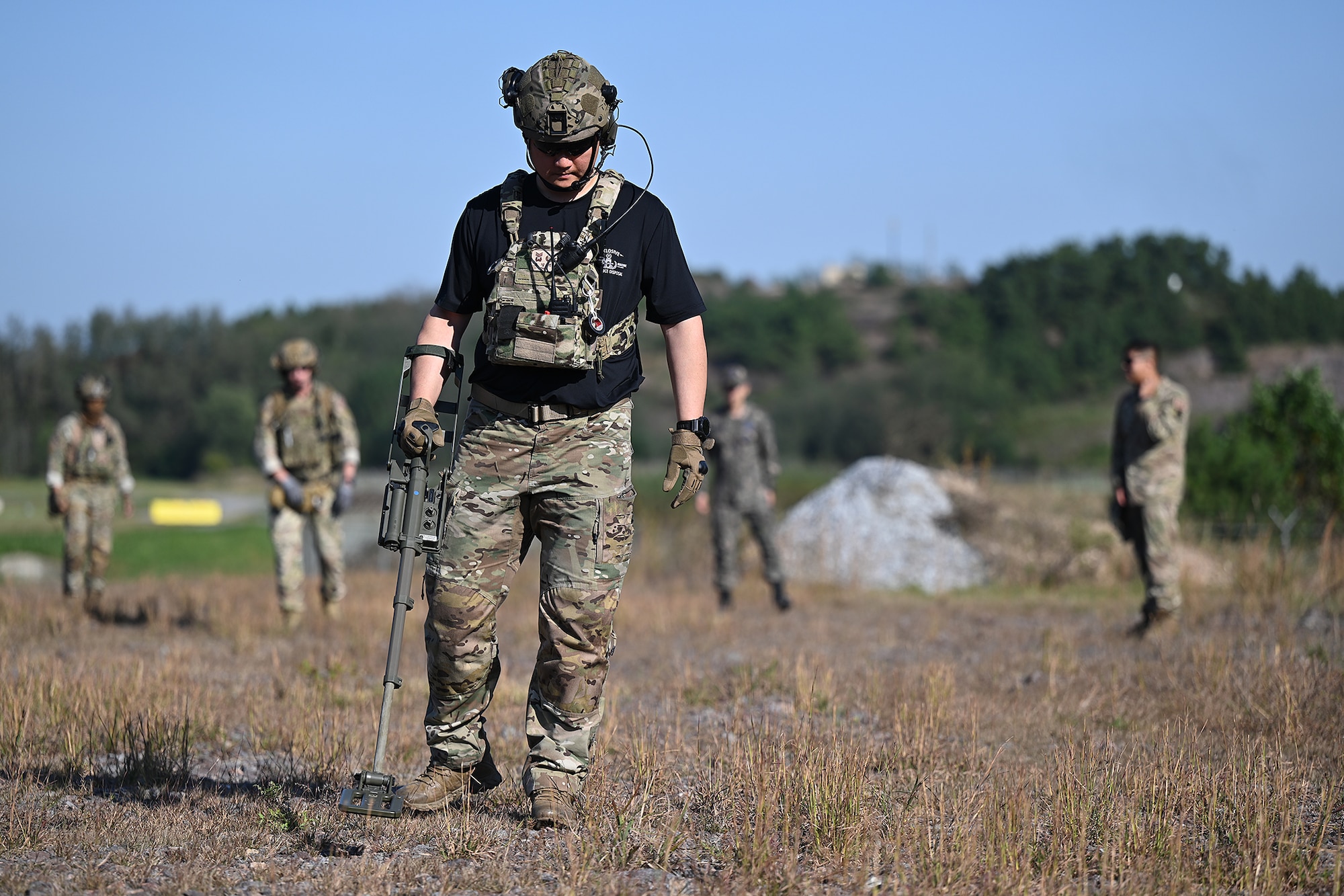 Senior Master Sgt. Oh Gyeong Taek, Republic of Korea Air Force 38th Fighter Group explosive ordnance disposal technician, sweeps a field for simulated improvised explosive devices during joint EOD training with U.S. Air Force Airmen assigned to the 8th Civil Engineer Squadron EOD at Kunsan Air Base, ROK.