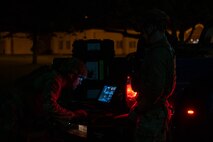 U.S. Air Force Senior Airman Justin Chamberlain, left, and Airman 1st Class Liam Brennan, 35th Civil Engineer Squadron explosive ordnance disposal technicians, operate a Man Transportable Robotics System.