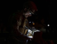 U.S. Air Force Senior Airman Justin Chamberlain, 35th Civil Engineer Squadron explosive ordnance disposal technician, retrieves equipment from his bag.