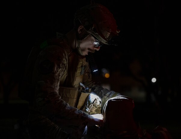 U.S. Air Force Senior Airman Justin Chamberlain, 35th Civil Engineer Squadron explosive ordnance disposal technician, retrieves equipment from his bag.