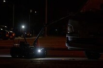 A Man Transportable Robotics System utilized by the 35th Civil Engineer Squadron explosive ordnance disposal flight approaches a van with simulated unexploded ordnance.