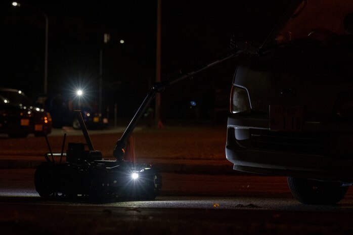 A Man Transportable Robotics System utilized by the 35th Civil Engineer Squadron explosive ordnance disposal flight approaches a van with simulated unexploded ordnance.
