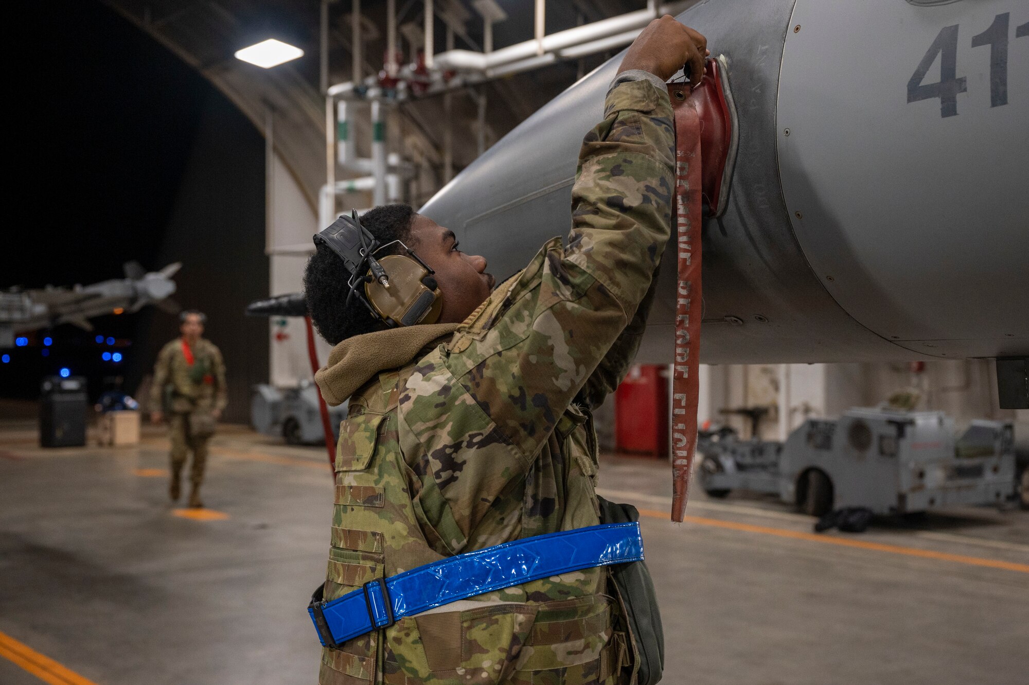 A U.S. Air Force Airman assigned to the 35th Maintenance Group places a cap on an F-16 Fighting Falcon Jet during the Beverly Sunrise 24-6 exercise at Misawa Air Base, Japan, Oct. 24, 2024.