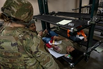 U.S. Air Force medical personnel assigned to the 35th Medical Group simulate taking an x-ray of a casualty actor during the Beverly Sunrise 24-6 exercise at Misawa Air Base, Japan, Oct. 24, 2024.