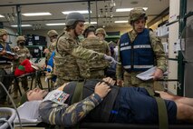 A U.S. Air Force Airman assigned to the 35th Medical Group, describes the Injuries of a casualty actor to a Wing Inspection Team (WIT) member during the Beverly Sunrise 24-6 exercise at Misawa Air Base, Japan, Oct. 24, 2024.