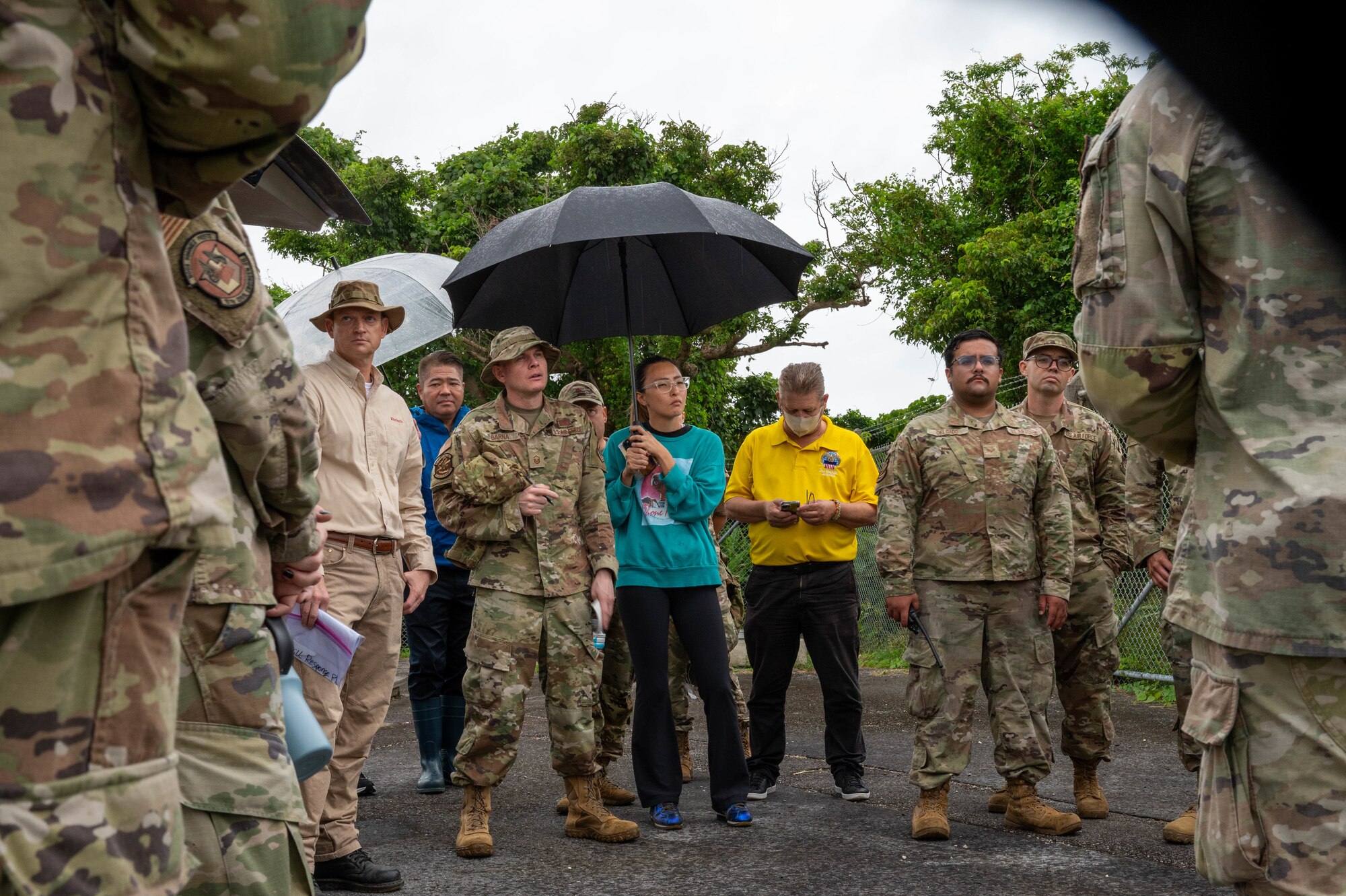 Airmen and contractors discuss spill response curriculum after a training scenario.